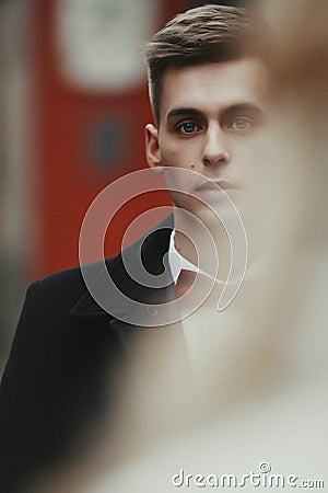 Handsome innocent blonde groom with blue eyes in a street face c Stock Photo