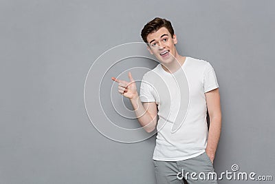 Handsome inspired male pointing away on copyspace Stock Photo