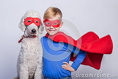 Handsome little superman with dog. Superhero. Halloween. Studio portrait over white background Stock Photo