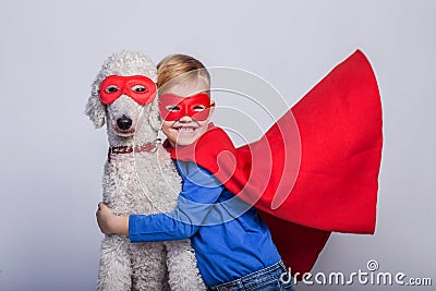 Handsome little superman with dog. Superhero. Halloween. Studio portrait over white background Stock Photo