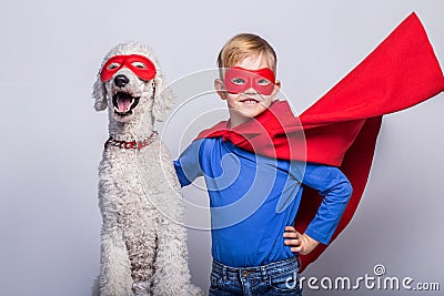 Handsome little superman with dog. Superhero. Halloween. Studio portrait over white background Stock Photo