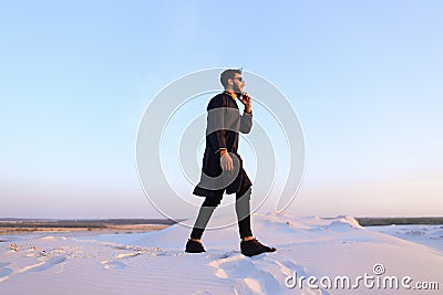 Handsome male Arab businessman talks on cellular business pro, s Stock Photo