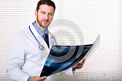 Handsome male doctor portrait holding patients x-ray Stock Photo