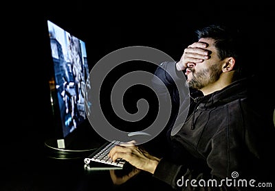 Handsome male gamer playing computer video game Stock Photo
