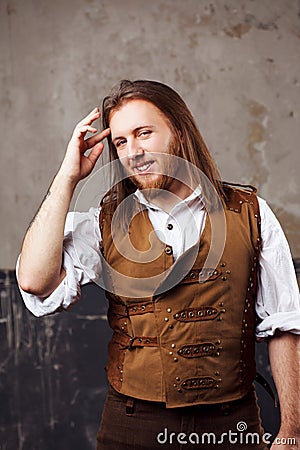 Handsome male Steam punk. Retro man portrait over grunge background. Stock Photo