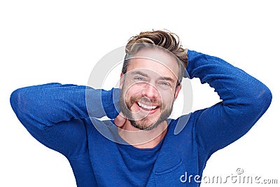 Handsome man with beard laughing with hands in hair Stock Photo