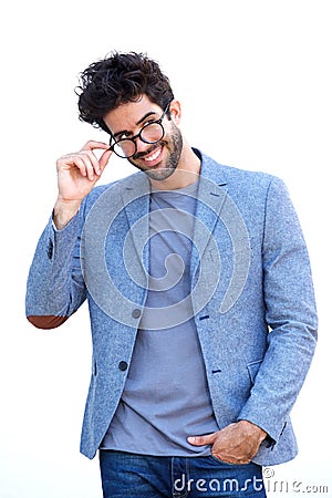 Handsome man in blue blazer standing with hand on glasses Stock Photo