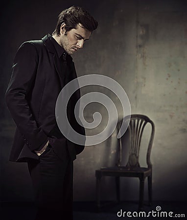 Handsome man in a business suit on a dark background Stock Photo