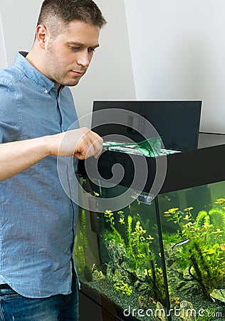 Handsome man catching fishes Stock Photo