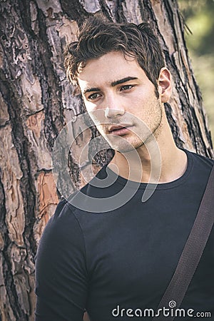 Handsome man close portrait near a tree Stock Photo