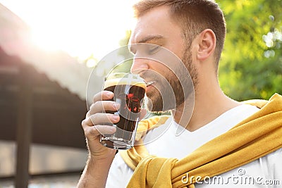 Handsome man with cold kvass. Traditional Russian summer drink Stock Photo