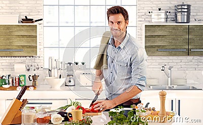 Handsome man cooking in kitchen at home Stock Photo