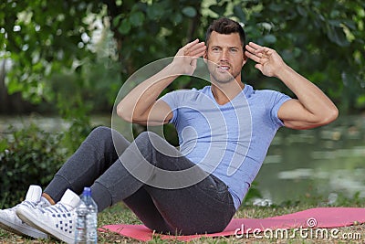 handsome man doing exercise outdoors Stock Photo