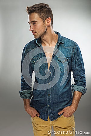 Handsome man in fashionable dress posing in jeans Stock Photo