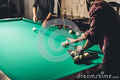 handsome man forming triangle of russian pool balls Stock Photo