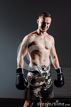 Handsome man or healthy boxer or Thai boxer with six pack wearing boxing gloves Stock Photo