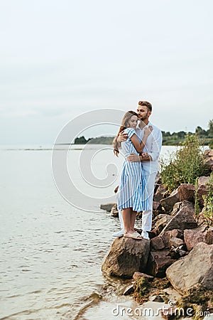 Handsome man hugging beautiful woman in Stock Photo