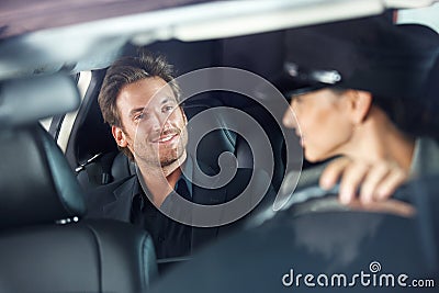 Handsome man in luxury car smiling Stock Photo