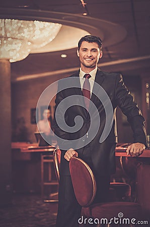 Handsome man in luxury casino interior Stock Photo