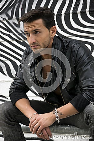 Handsome man outdoor in front of zebra striped graffiti Stock Photo