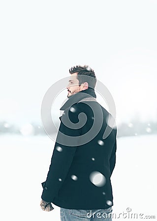 Handsome man outdoors standing in the winter blizzard Stock Photo