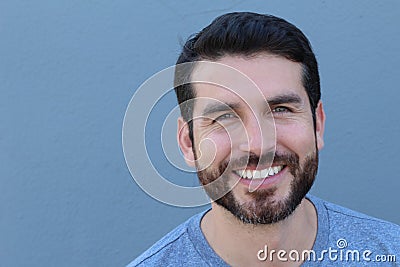 Handsome man with perfect white smile on blue background with copy space Stock Photo