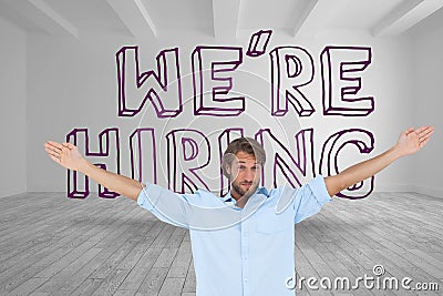 Handsome man raising arms in front of were hiring graphic Stock Photo