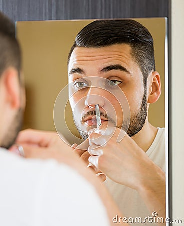 Handsome man remove hair with scissors Stock Photo