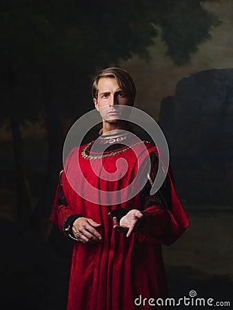 Handsome man in a Royal red doublet. Stock Photo
