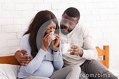 Handsome man taking care about his sick pregnant woman Stock Photo