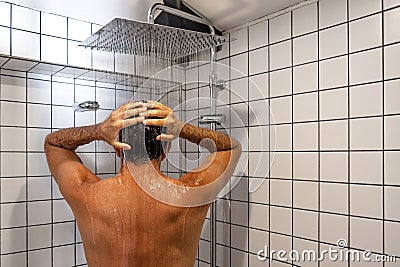 Handsome man taking shower in white bathrooom shower cabing Stock Photo