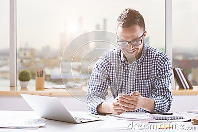 Handsome man using cellular phone Stock Photo