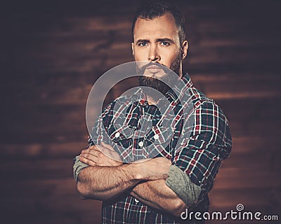 Handsome man in wooden rural house interior Stock Photo