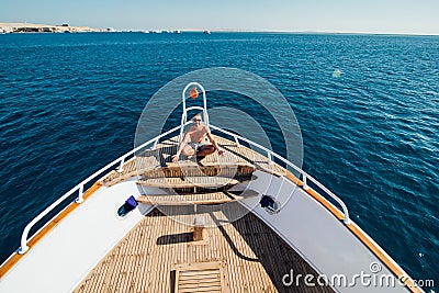 Handsome man on a yacht in the summer. Rest on the yacht, Sits on the deck of the yacht Stock Photo