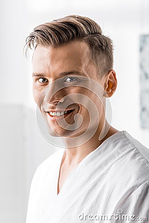 Handsome masseur looking at camera in clinic Stock Photo