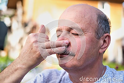 Handsome mature man breathing yoga pranayama on summer sunny day outside. Stock Photo