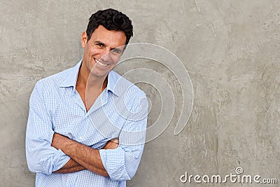 Handsome mature man standing by wall Stock Photo