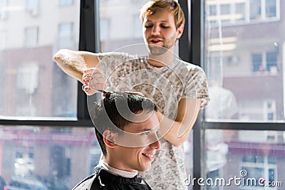 Handsome man at the hairdresser getting a new haircut Stock Photo