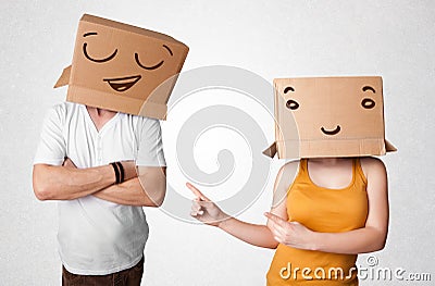 Handsome men in suit gesturing with drawn smiley faces on box Stock Photo