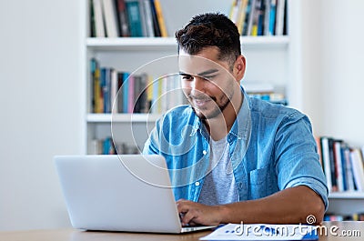 Handsome mexican hipster man sending email with laptop Stock Photo