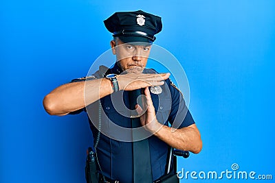 Handsome middle age mature man wearing police uniform doing time out gesture with hands, frustrated and serious face Stock Photo