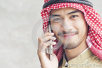 Handsome modern Arabian man using holding smart tablet Stock Photo