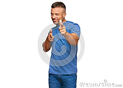 Handsome muscle man wearing casual clothes pointing fingers to camera with happy and funny face Stock Photo