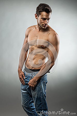 Handsome muscular man posing half naked Stock Photo