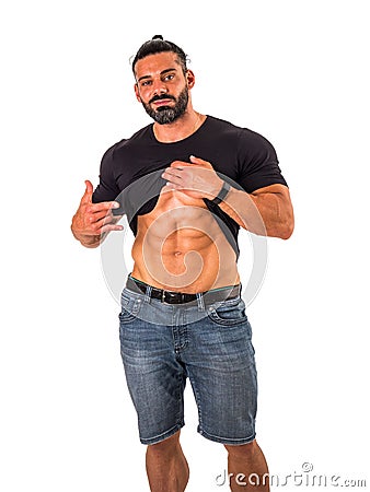 Handsome,muscular man pulling up t-shirt revealing abs. Isolated Stock Photo
