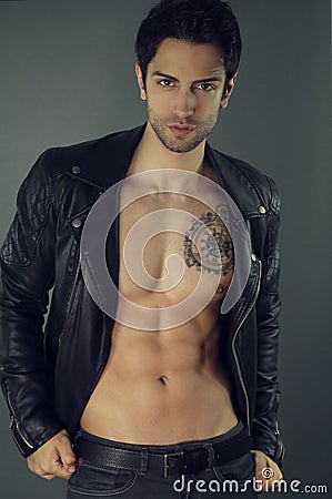 Handsome muscular man wearing a black leather jacket Stock Photo