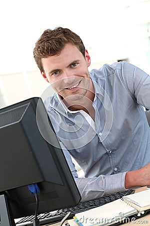 Handsome office worker on computer Stock Photo