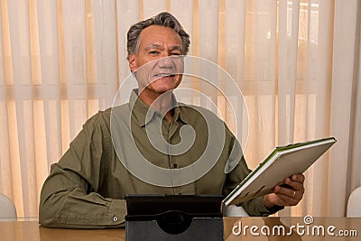 Handsome Older Gentleman Working in his Home Office Stock Photo