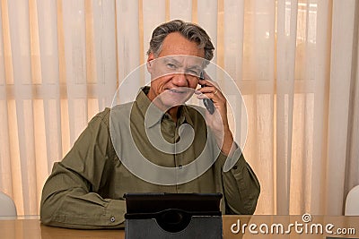 Handsome Older Gentleman Working in his Home Office Stock Photo