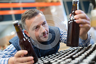 Handsome packer on packaging line at manufacture Stock Photo